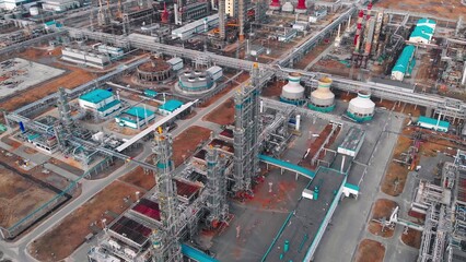 View of a large industrial chemical plant with pipelines, coolers and distillation towers for the production of plastics and polymers from oil production waste and associated petroleum gas.