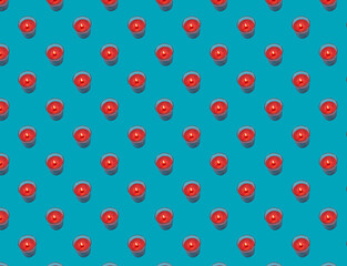 Seamless pattern of red candles on a blue background.