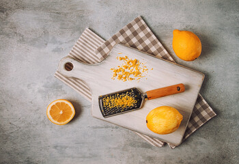 Grated lemon zest, on a cutting board, with a grater , top view, no people,