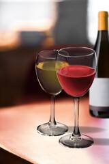 Wines assortment. Red, white wine in glasses and bottles on table background. Wine bar, shop, tasting concept