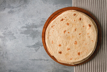 A stack of Mexican tortillas, on a gray table, top view, close-up, no people,