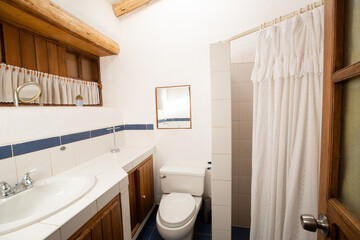 View of a rural bathroom. White room for hygiene in rural house. Bathroom in family home.
