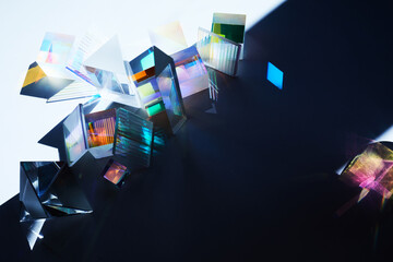 Geometric figures prisms with light diffraction of spectrum colors and reflection with trendy light