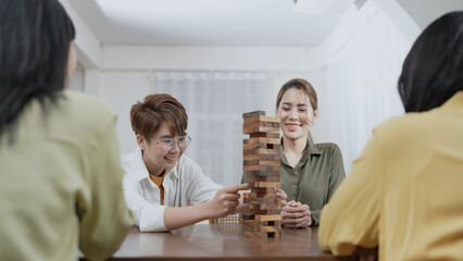 Holiday concept of 4k Resolution. Group of Asian female friends playing games together at home. Fun and exciting leisure activities.