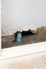 Concrete walls in the shade that have been smashed or destroyed to find holes for water leaks. Home repair concept.
