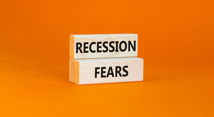 Recession fears symbol. Concept words Recession fears on wooden blocks on a beautiful orange table orange background. Business and recession fears concept. Copy space.