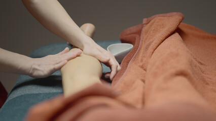 Obraz na płótnie Canvas Woman getting legs lymphatic drainage massage in spa salon. Action. Body relaxation, beauty, and body care concept.