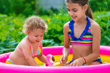 Children swim in the pool. Selective focus.
