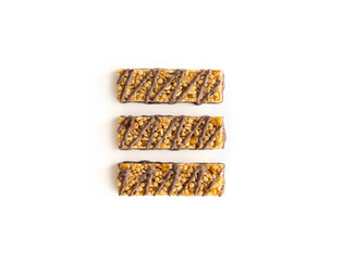 Three popcorn bars with chocolate and caramel on a white background. Quick sweet snack.