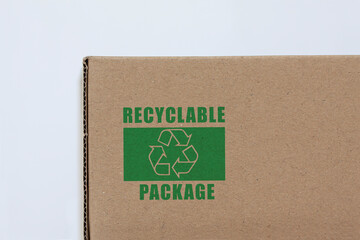Cardboard pakage with printed recycling symbol. Photo with while background.