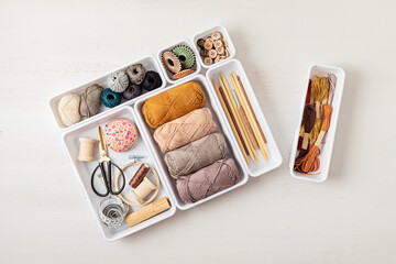 Craft hobby background with yarn in natural colors. Recomforting hobby to reduce stress for cold fall and winter weather. Mock up, copy space, top view