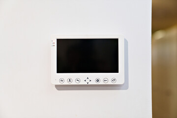 intercom screen on a white wall. home security and video surveillance.