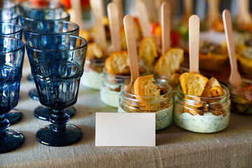 small glass jars with sauce and croutons. catering services for the party. 