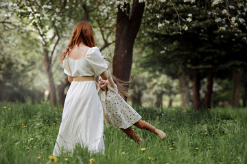 Mom and little daughter in the apple orchard