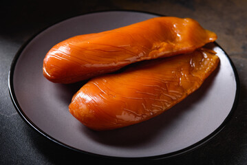 Juicy Shiny Dried Chicken Breast lies on Gray Plate. View from Above. Whole Piece of Meat.