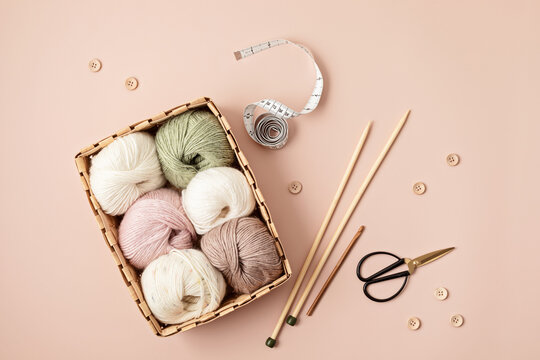 Craft hobby background with yarn in natural colors. Recomforting hobby to reduce stress for cold fall and winter weather. Mock up, copy space, top view