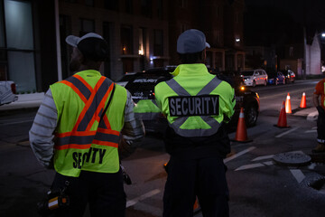Security guard in car patroling at construction site at night  city