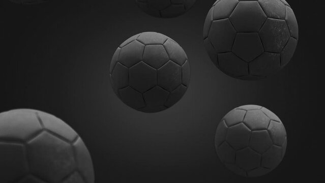 Black soccer ball falling in slow motion, looped switch