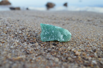 Green quartz stone on the beach