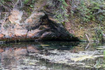 Mirror cliffs and an old river channel in a very beautiful forest in Cirulu nature trails, Latvia.
