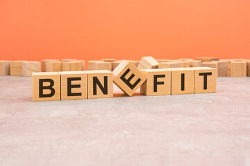 word benefit made with wood blocks. text is written in black letters, light background