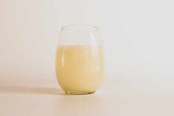 glass of milk on white table, white background