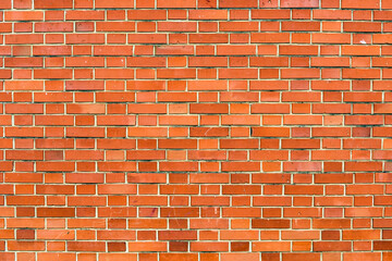 Red brick wall background. Horizontal shot of brickwork pattern as textured graphic design element.