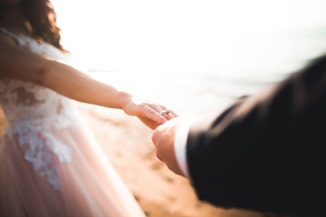Wedding couple bride and groom holding hands
