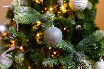 Classic Christmas decorated New year tree. Christmas tree with wite and silver decorations, ornaments toy and ball. Modern classical style interior design apartment. Christmas eve at home