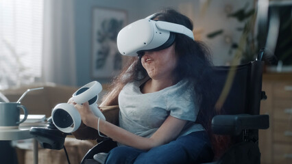 At home woman with disability in a wheelchair wearing virtual reality headset with controllers...