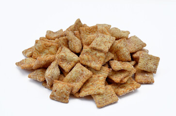 ready breakfast whole grain flakes cinnamon pads isolated on white background