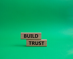 Build trust symbol. Wooden blocks with words Build trust. Beautiful green background. Business and Build trust concept. Copy space.