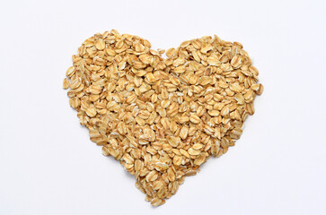 oatmeal scattered in a heart shape on a white background