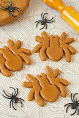 Cutting Halloween gingerbread in shape of spiders