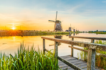 Dutch landscape, windmills at Kinderdijk village, a famous authentic attraction in the Netherlands.