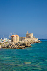 Windmills of Mandraki harbour and Saint Nicholas Fortress in Rhodes town, Greece, Europe. - obrazy, fototapety, plakaty
