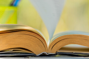 open book outdoors with stacked book