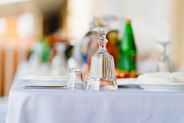 inverted glasses on the table. table setting for an outdoor holiday.