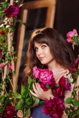 Naklejka premium fabulous. a beautiful and gentle woman in peony flowers. feminine beauty. 