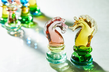 Glass chess is on a glass surface. High quality photo