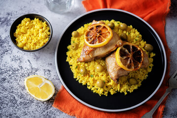Moroccan fried chicken breast with curry rice in a plate