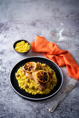 Moroccan fried chicken breast with curry rice in a plate