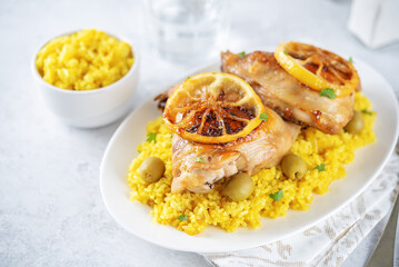 Moroccan fried chicken breast with curry rice in a plate