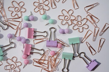 Top view of office supplies - paper clips, clothespins and more