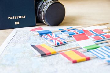 Flags on travel map, camera, blue international passport. travel destination planning concept.