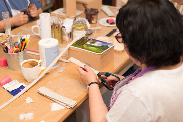 Women in art workshop making decoupage boxes