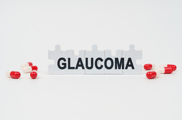 On a white surface are tablets and puzzles with the inscription - GLAUCOMA