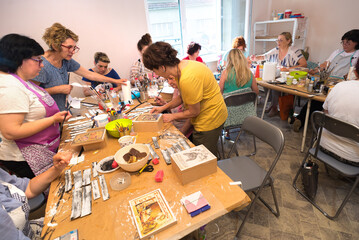 Women in art workshop making decoupage boxes