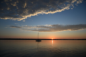 A sailboat anchored off South Twin Island in Lake Superior during sunset at the Apostle Islands National Lakeshore.