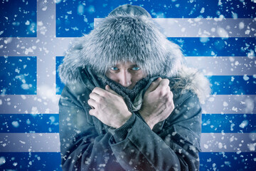 Isolate. Cold weather. Bask. A man in a fur hat and scarf warms his hands with his mouth. It's...